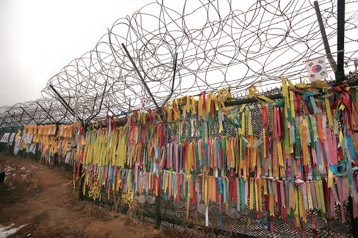 Prayer ribbons tied to a barbed wire fence located between the DMZ and Freedom Bridge