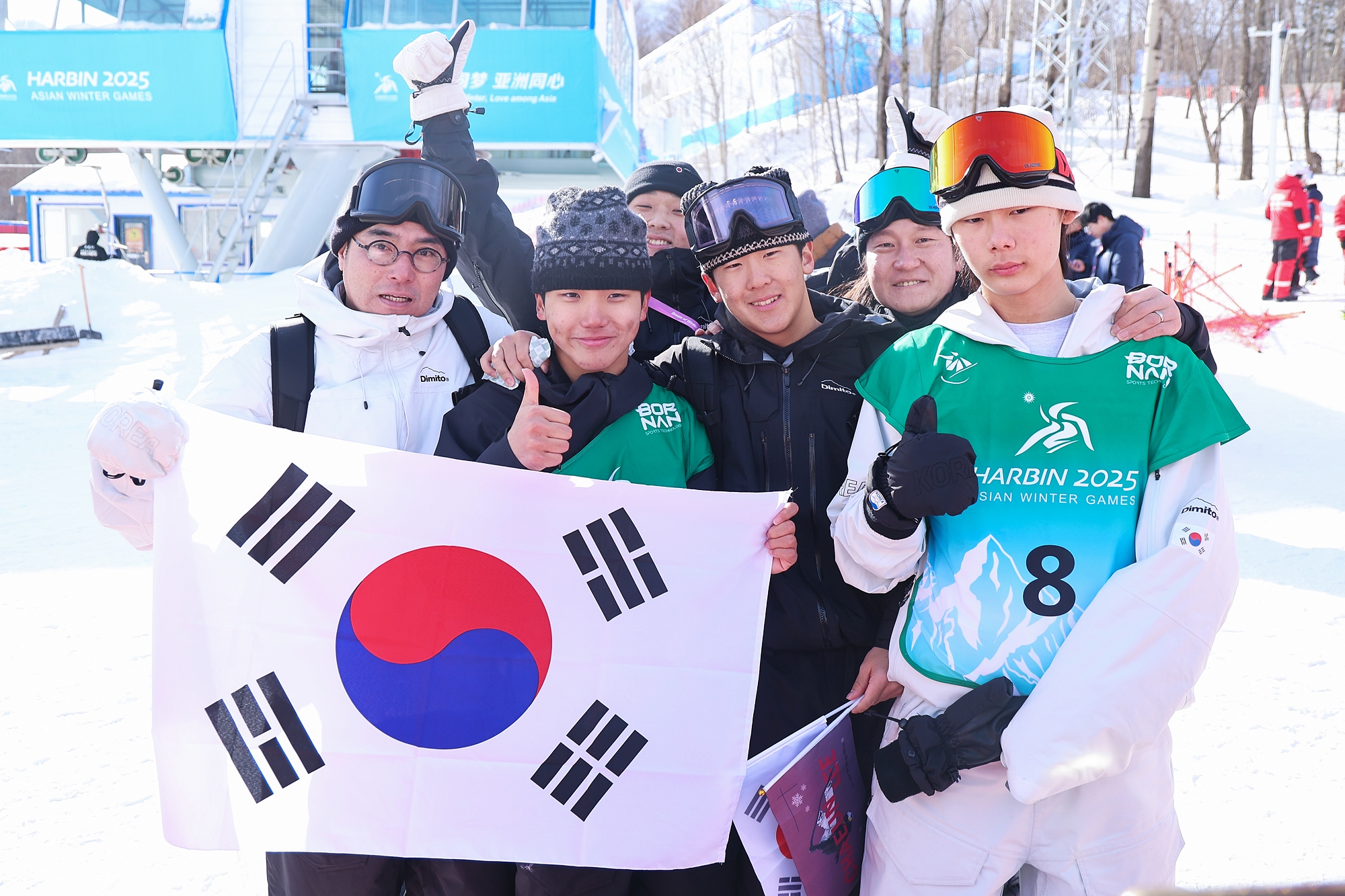 Les médailles d’or Kim Geonhui (2e à gauche) et de bronze Lee Jio (dernier à droite) posent avec leur équipe au Yaburi Ski Resort, en Chine, le 13 février 2025. © Agence de presse Yonhap