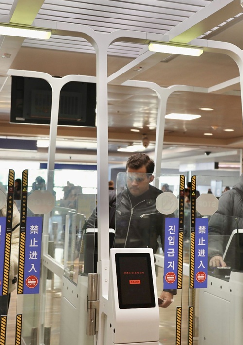 Un homme utilise un dispositif automatisé de contrôle des entrées et des sorties installé à l’aéroport d’Incheon. © Ministère de la Justice
