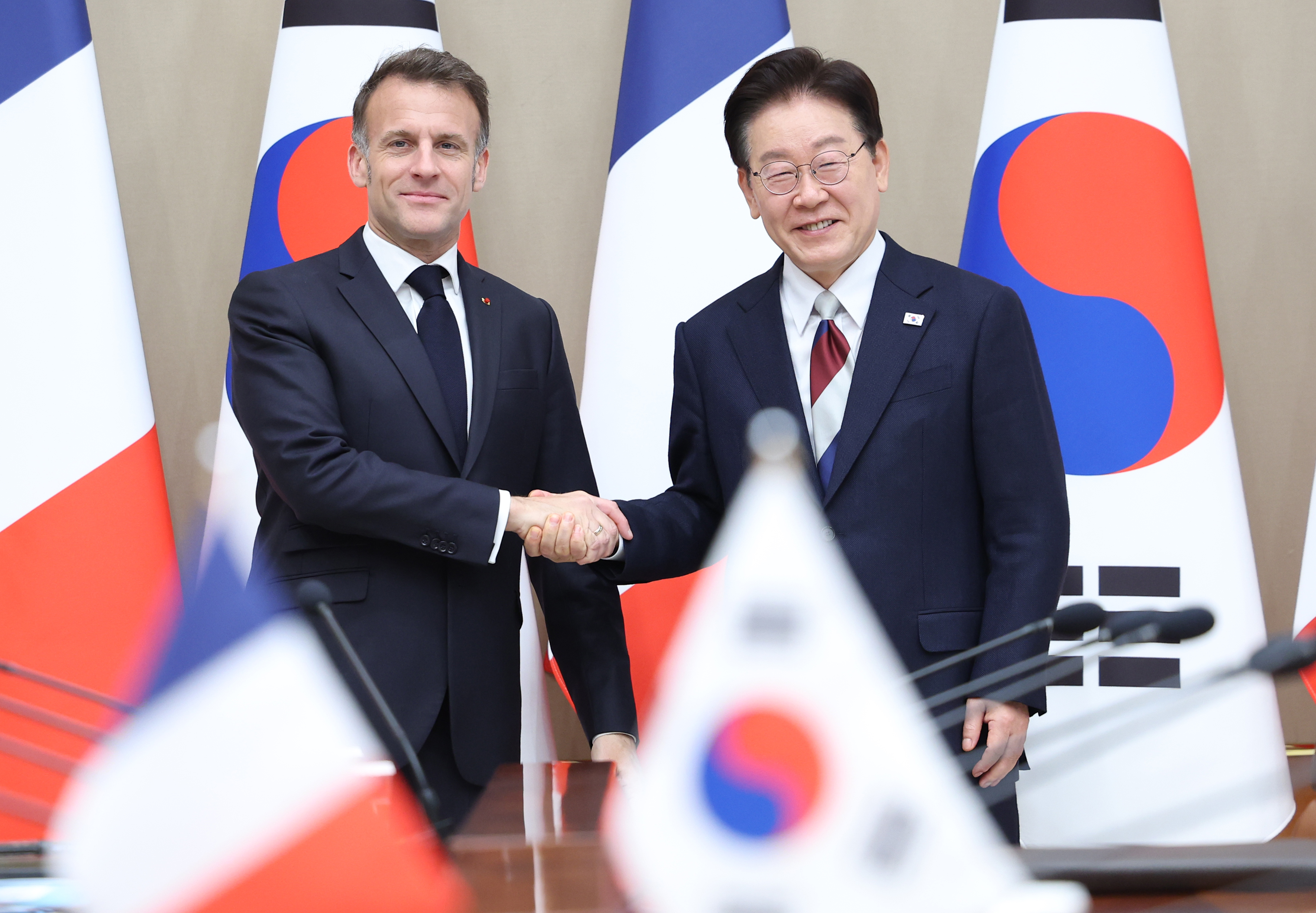 Le président Lee Jae Myung échange une poignée de main avec son homologue français Emmanuel Macron, au complexe présidentiel de Cheong Wa Dae, à Séoul, le 3 avril 2026. © Agence de presse Yonhap