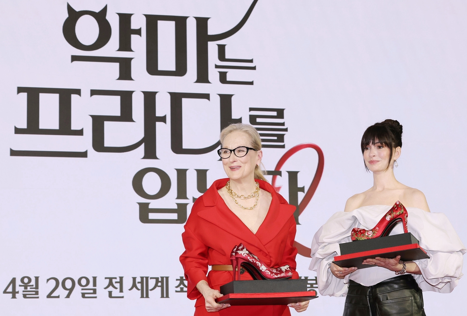 Meryl Streep et Anne Hathaway posent avec leurs paires d’escarpins rouges décorées de motifs traditionnels coréens, à Séoul, le 8 avril 2026. © Lee Jeong Woo / Korea.net