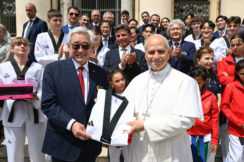 Le pape L&eacute;on XIV pose avec un dobok et la ceinture noire 10e dan de taekwondo aux c&ocirc;t&eacute;s du pr&eacute;sident de la f&eacute;d&eacute;ration mondiale de taekwondo, Chungwon Choue, au Vatican, le 3 juin 2026. &copy; F&eacute;d&eacute;ration mondiale de taekwondo