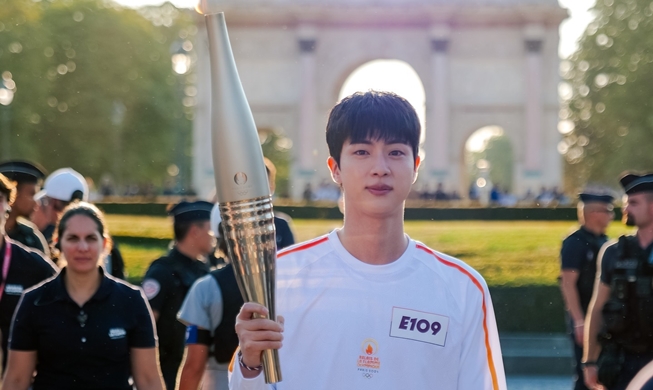 Le soutien d'Army venus nombreux au Louvre à Paris pour soutenir Jin de BTS, porteur de la flamme olympique 2024